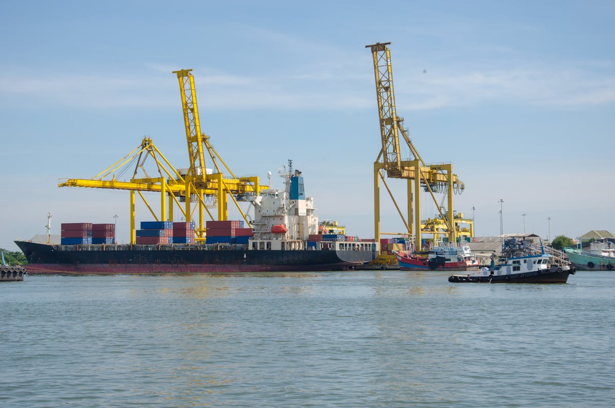 Cargo ship docked with industrial cranes